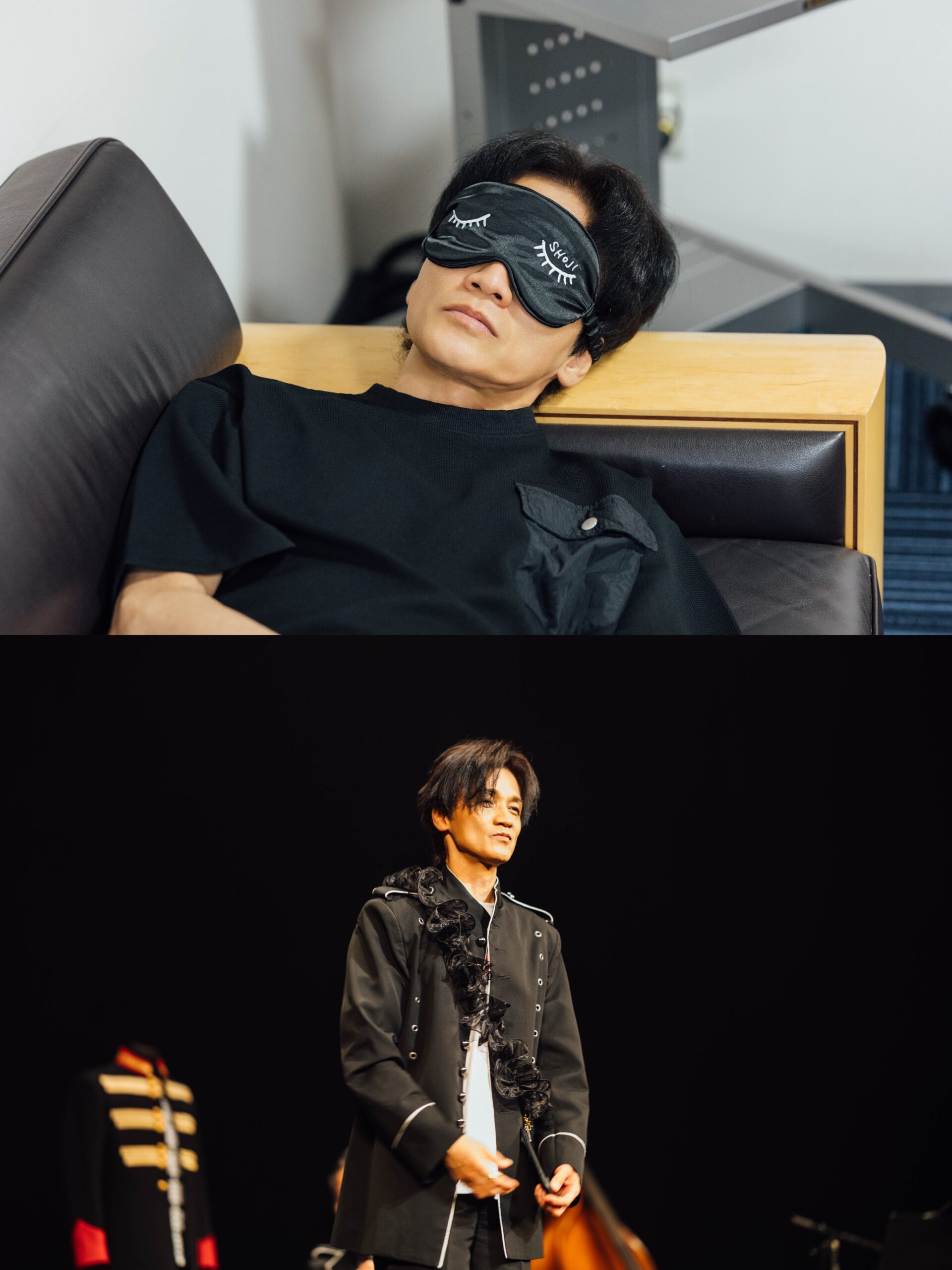 NSグッズ - 成田昭次オフィシャルサイト Man on stage in a black jacket with a ruffled scarf, looking to the side with a calm expression.
